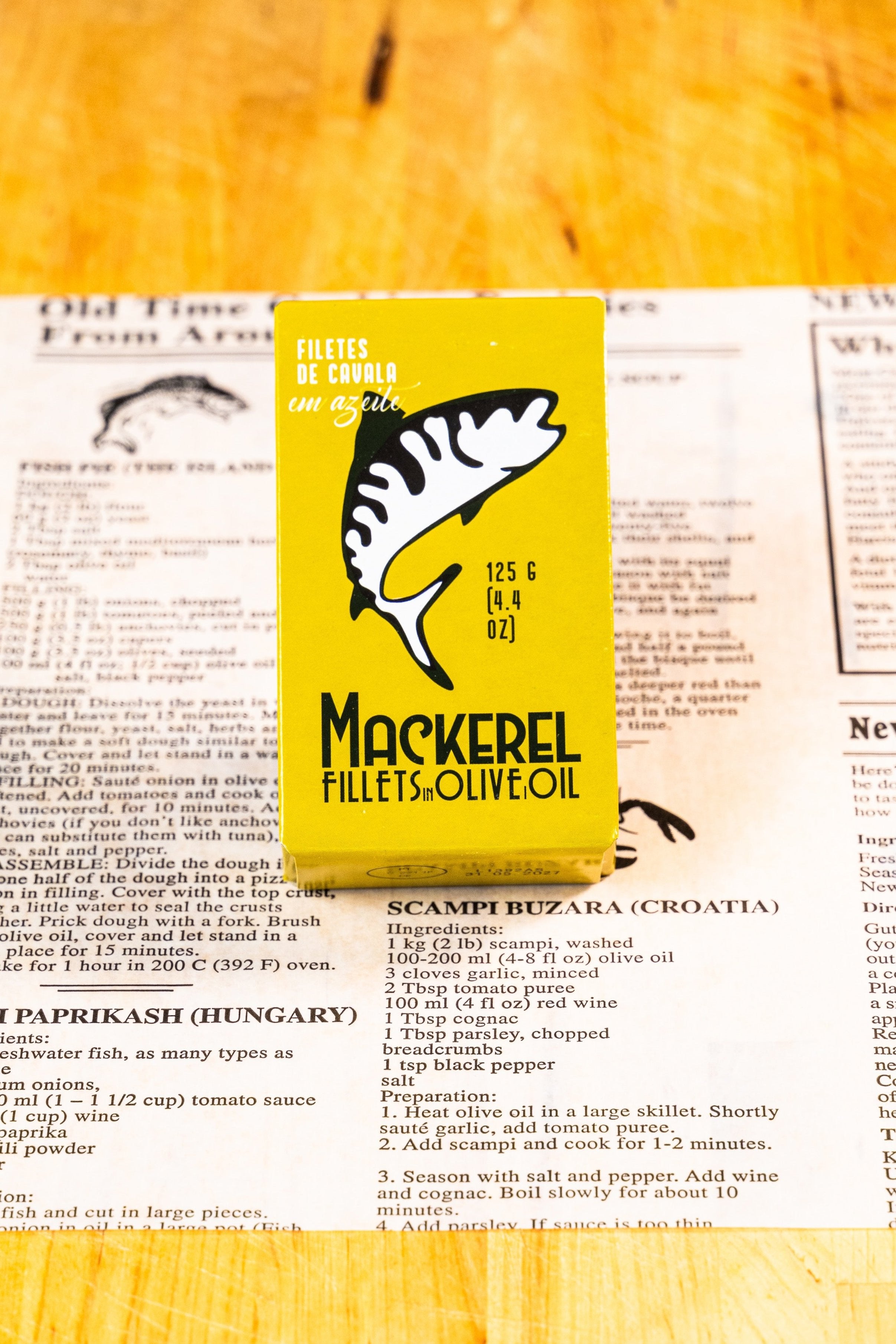 A yellow box containing mackerel filets in olive oil.